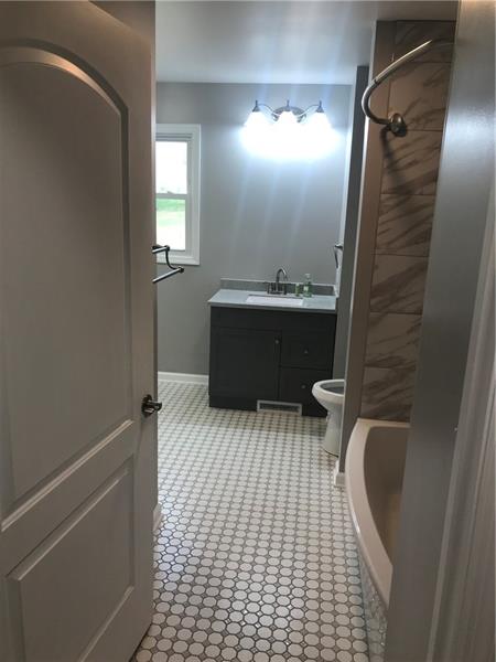 118 Sunflower Road Butler, PA 16001 - Photo 20 of 25 HUGE main bathroom has large vanity with storage, shelving for extra towels and large tub, laundry room and mechanical closet. The window provides great views of the back yard. (mirror to be placed above vanity)