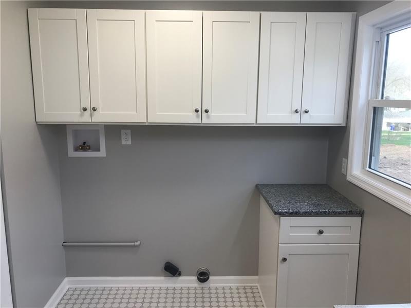 118 Sunflower Road Butler, PA 16001 - Photo 23 of 25 Large laundry area with folding table and tons of storage for bathroom or laundry room needs.