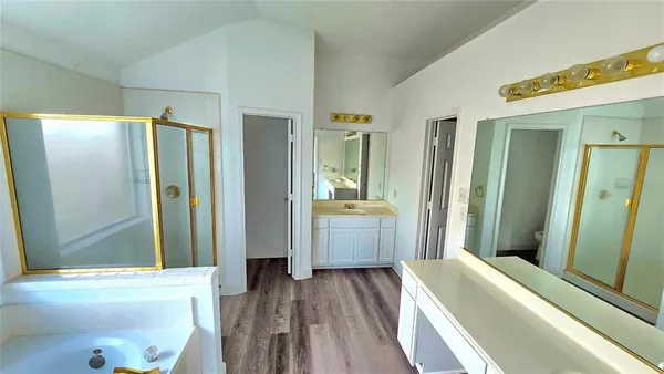 a bathroom with a bathtub a toilet and a shower