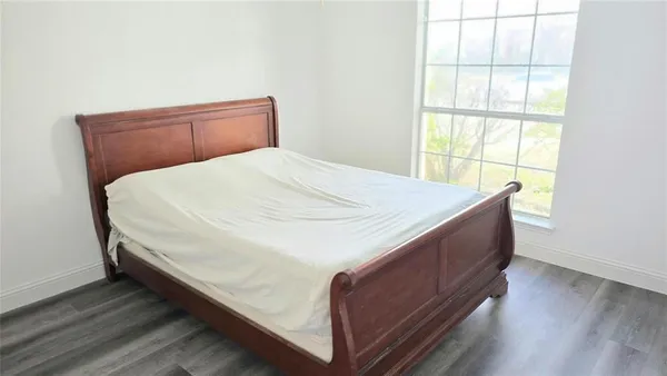 a bed sitting in a bedroom next to a window