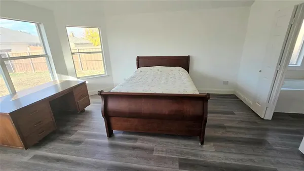 a room with wooden floor and window