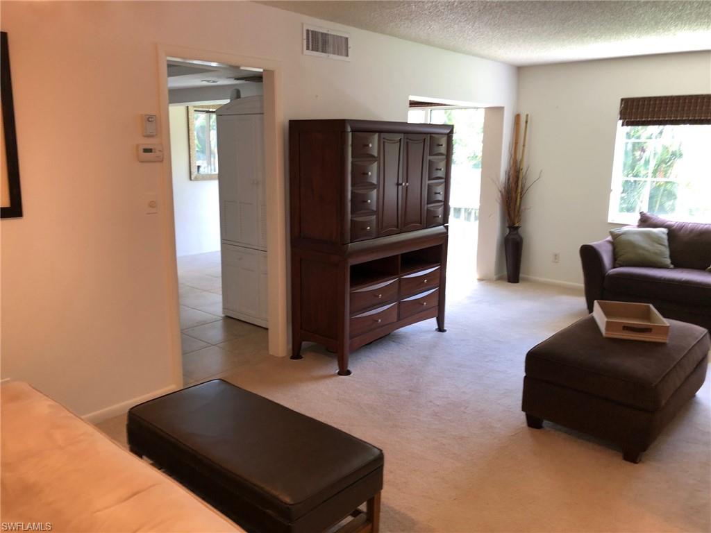 214 Bobolink Way, Unit 214B Naples, FL 34105 - Photo 2 of 12 a living room with furniture