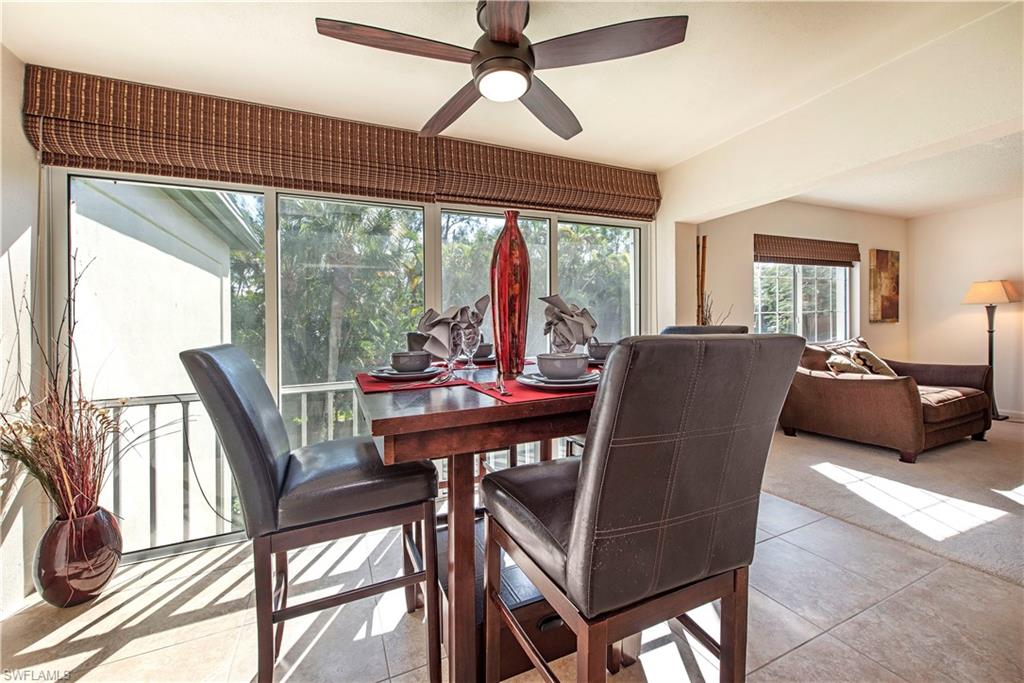 214 Bobolink Way, Unit 214B Naples, FL 34105 - Photo 4 of 12 a view of a dining room with furniture window and outside view