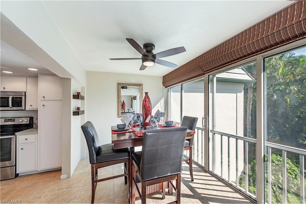 214 Bobolink Way, Unit 214B Naples, FL 34105 - Photo 5 of 12 a dining room with furniture window and wooden floor