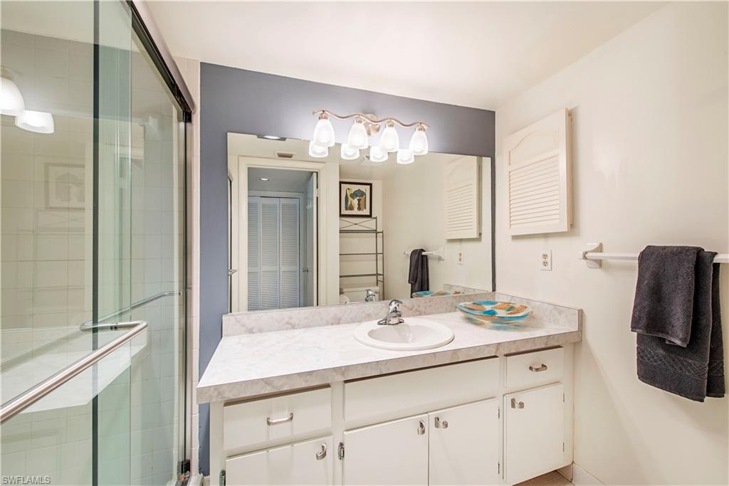 214 Bobolink Way, Unit 214B Naples, FL 34105 - Photo 9 of 12 a bathroom with a sink double vanity and a mirror