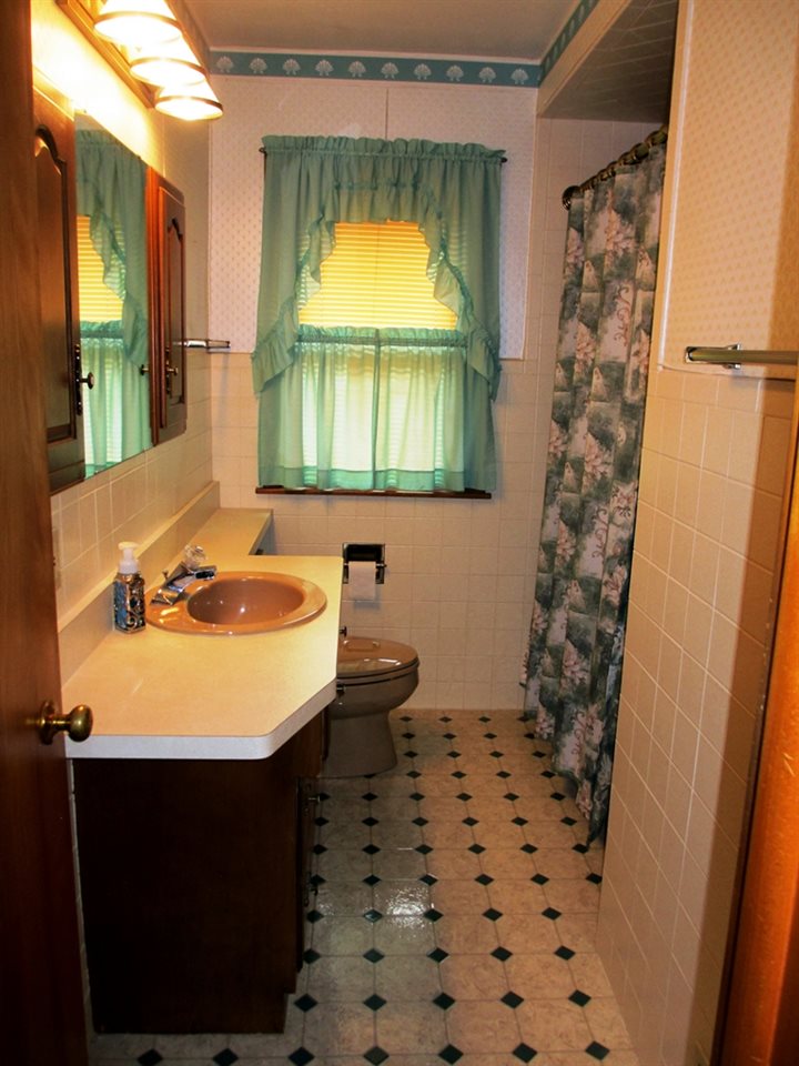 3729 Pinecrest Road Rockford, IL 61107 - Photo 12 of 22 a bathroom with a sink and a mirror