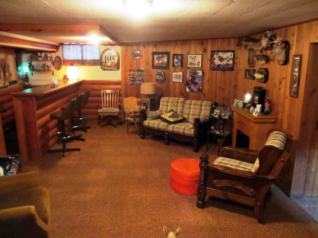 3729 Pinecrest Road Rockford, IL 61107 - Photo 17 of 22 a living room with furniture gym equipment and a chandelier