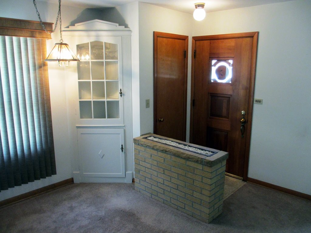 3729 Pinecrest Road Rockford, IL 61107 - Photo 6 of 22 an empty room with wooden floor and windows
