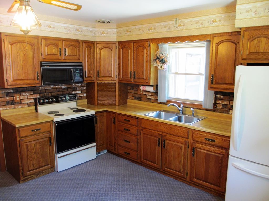 3729 Pinecrest Road Rockford, IL 61107 - Photo 8 of 22 a kitchen with stainless steel appliances granite countertop a sink stove and refrigerator