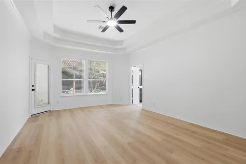 a kitchen with a stove a sink and a large window