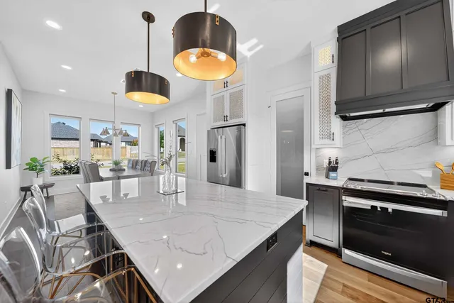 a kitchen with stainless steel appliances granite countertop counter space a sink and cabinets