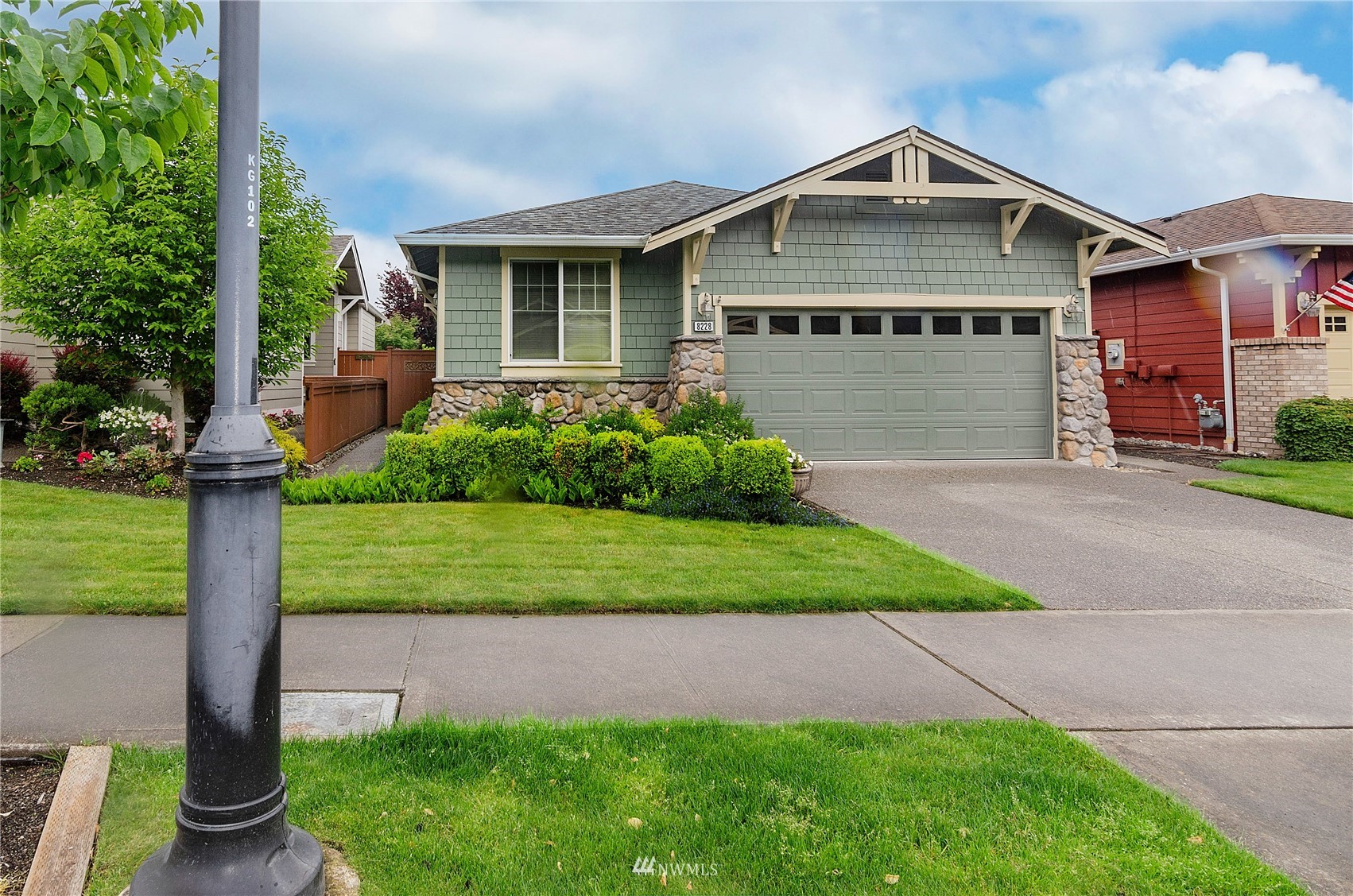 a front view of a house with a yard and potted plants