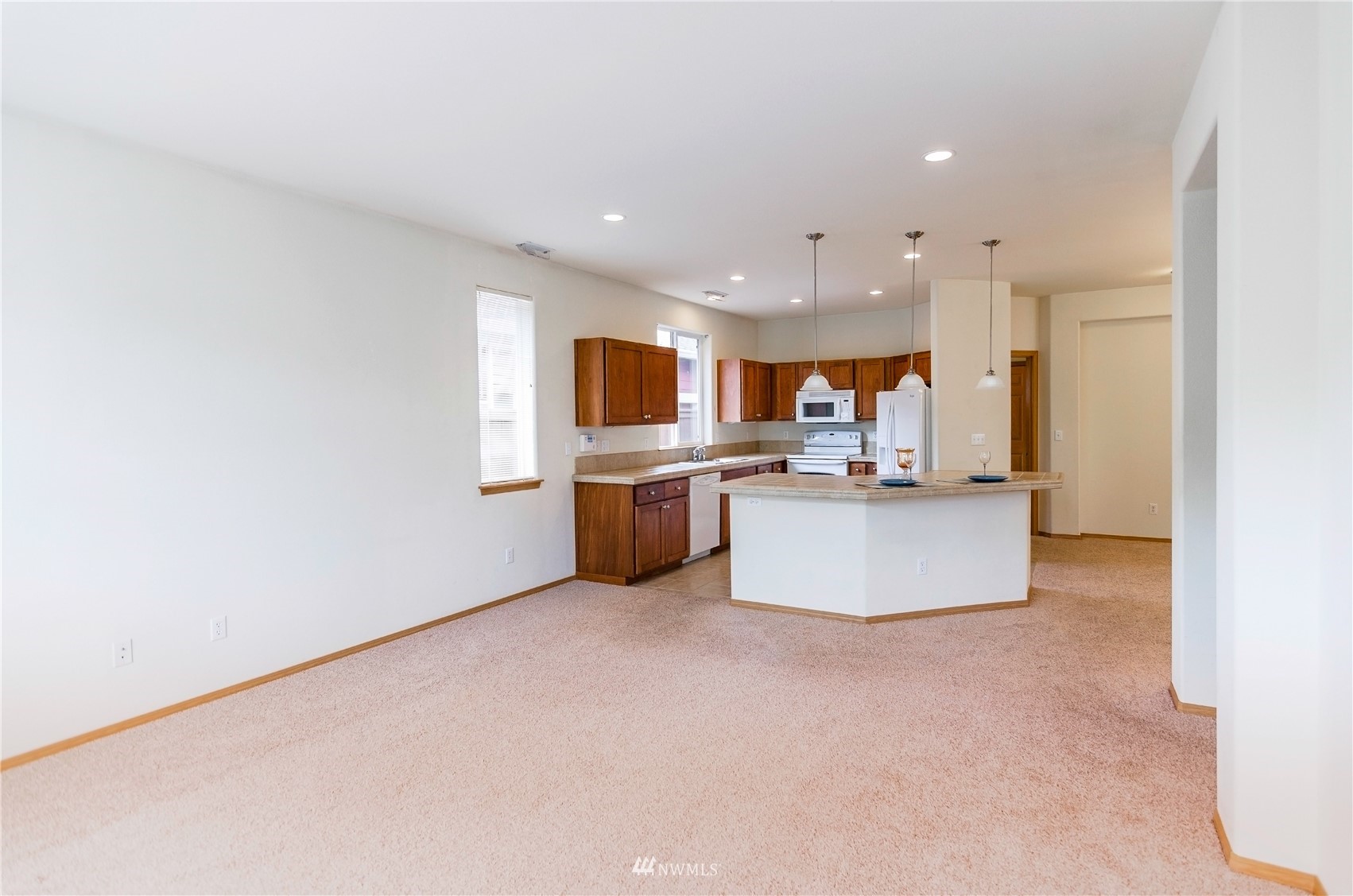 8228 Bainbridge Loop Northeast Lacey, WA 98516 - Photo 12 of 32 a view of kitchen with kitchen island a sink stainless steel appliances and cabinets