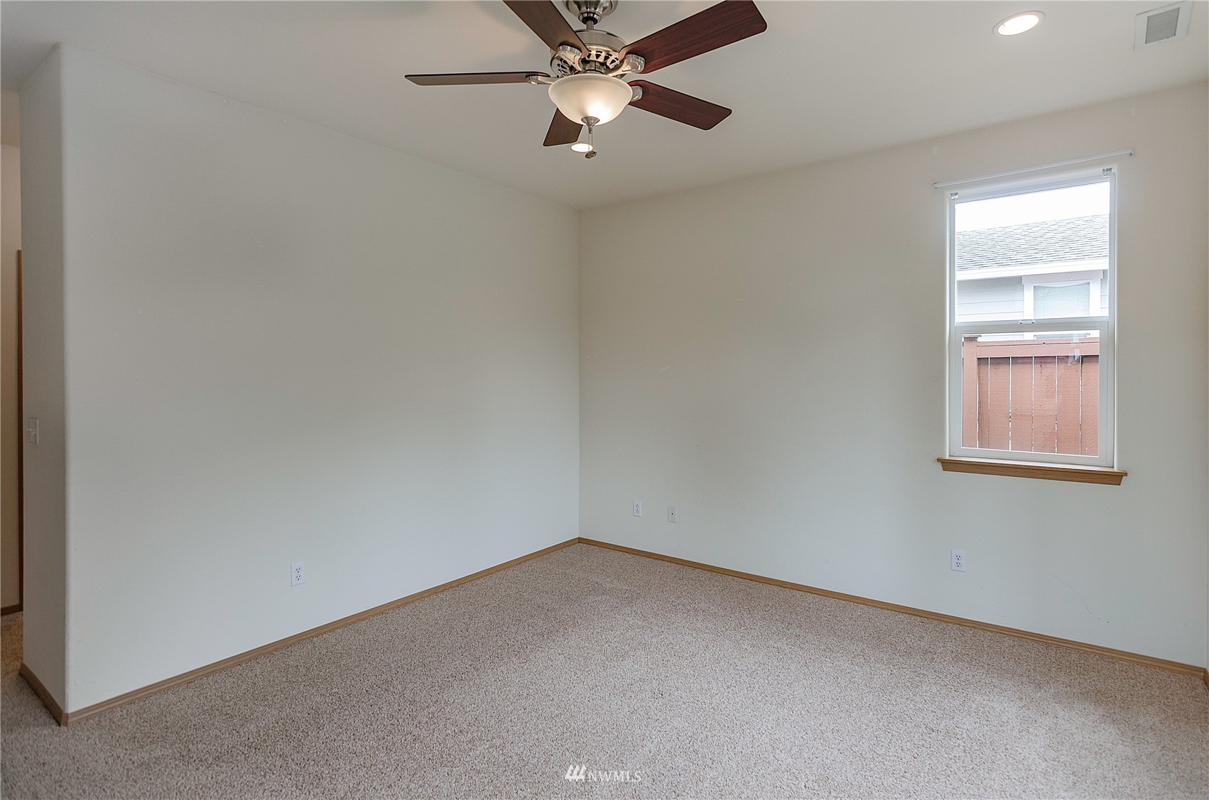 8228 Bainbridge Loop Northeast Lacey, WA 98516 - Photo 15 of 32 an empty room with a window and a fan