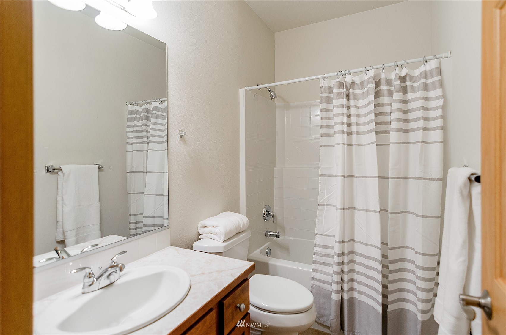 8228 Bainbridge Loop Northeast Lacey, WA 98516 - Photo 19 of 32 a bathroom with a sink toilet and shower