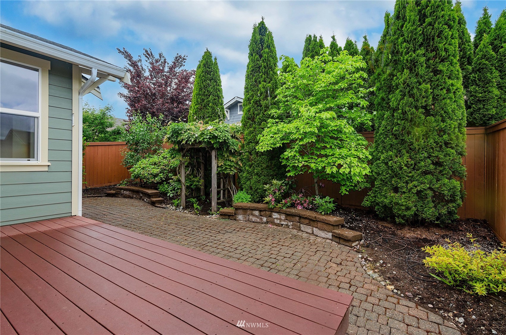 8228 Bainbridge Loop Northeast Lacey, WA 98516 - Photo 25 of 32 a view of a backyard with plants and a patio