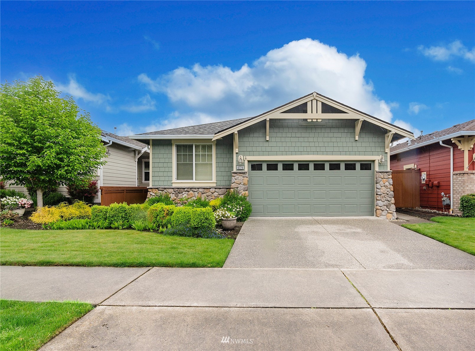 8228 Bainbridge Loop Northeast Lacey, WA 98516 - Photo 26 of 32 a front view of a house with a yard and garage