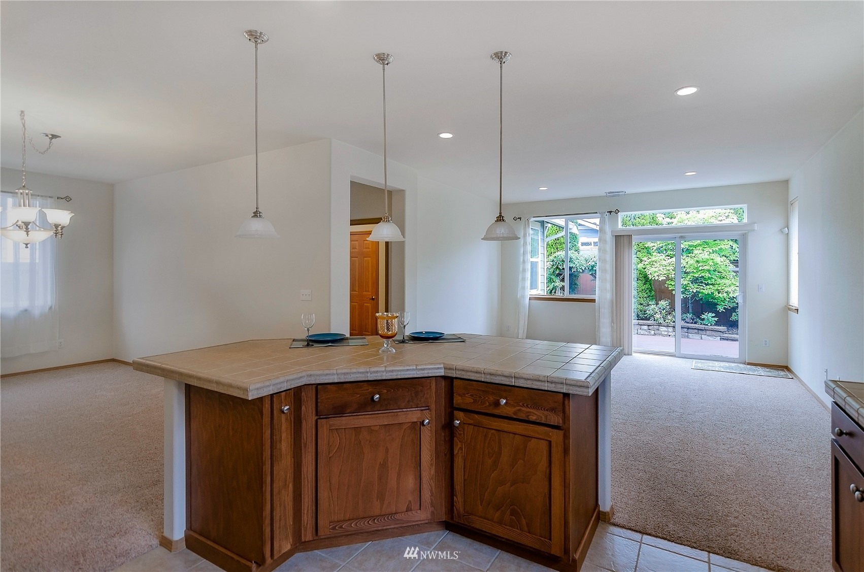 8228 Bainbridge Loop Northeast Lacey, WA 98516 - Photo 5 of 32 a kitchen with kitchen island a counter top space a sink a window and wooden floor