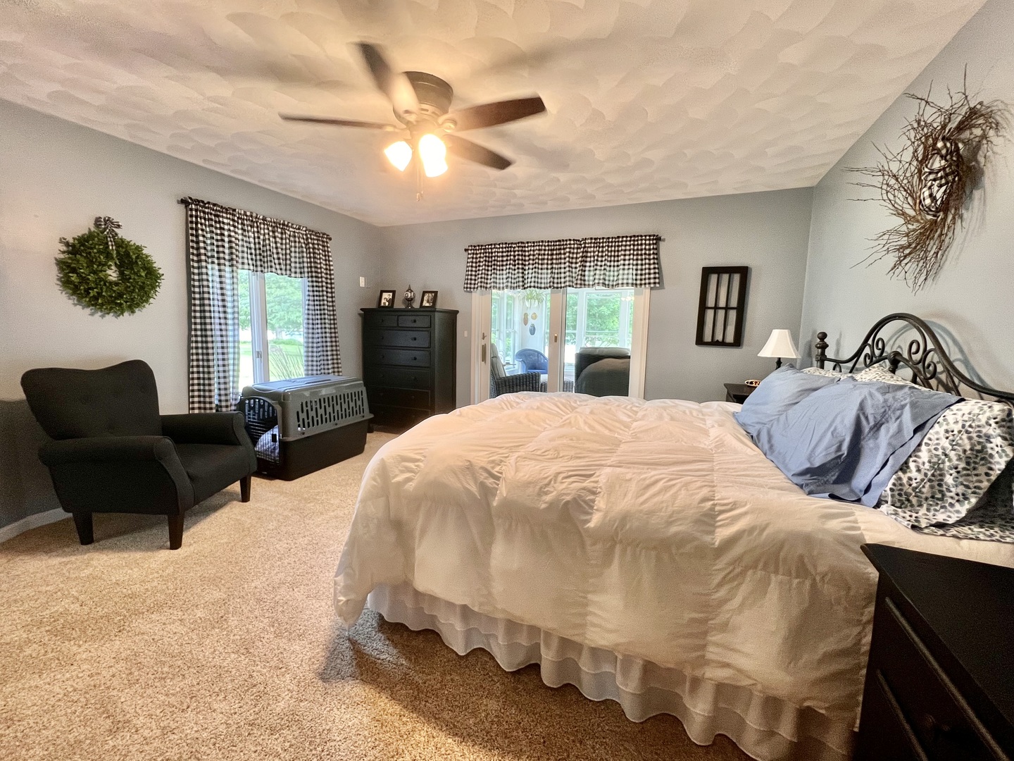 329 Rockside Drive Dixon, IL 61021 - Photo 9 of 23 a large bed sitting in a bedroom next to a window with a large mirror and a couch