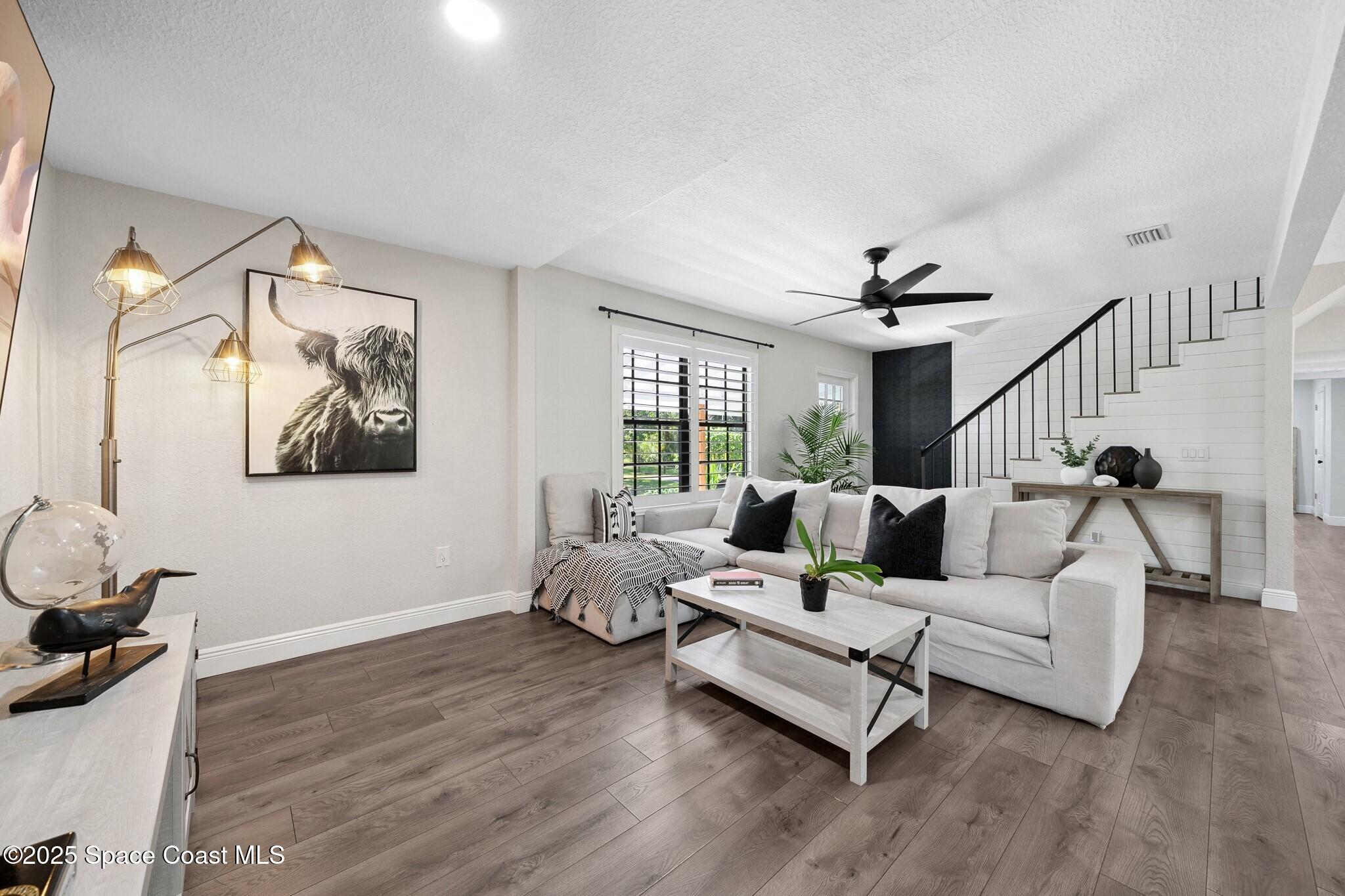 1325 Friday Road Cocoa, FL 32926 - Photo 11 of 59 a living room with furniture and wooden floor