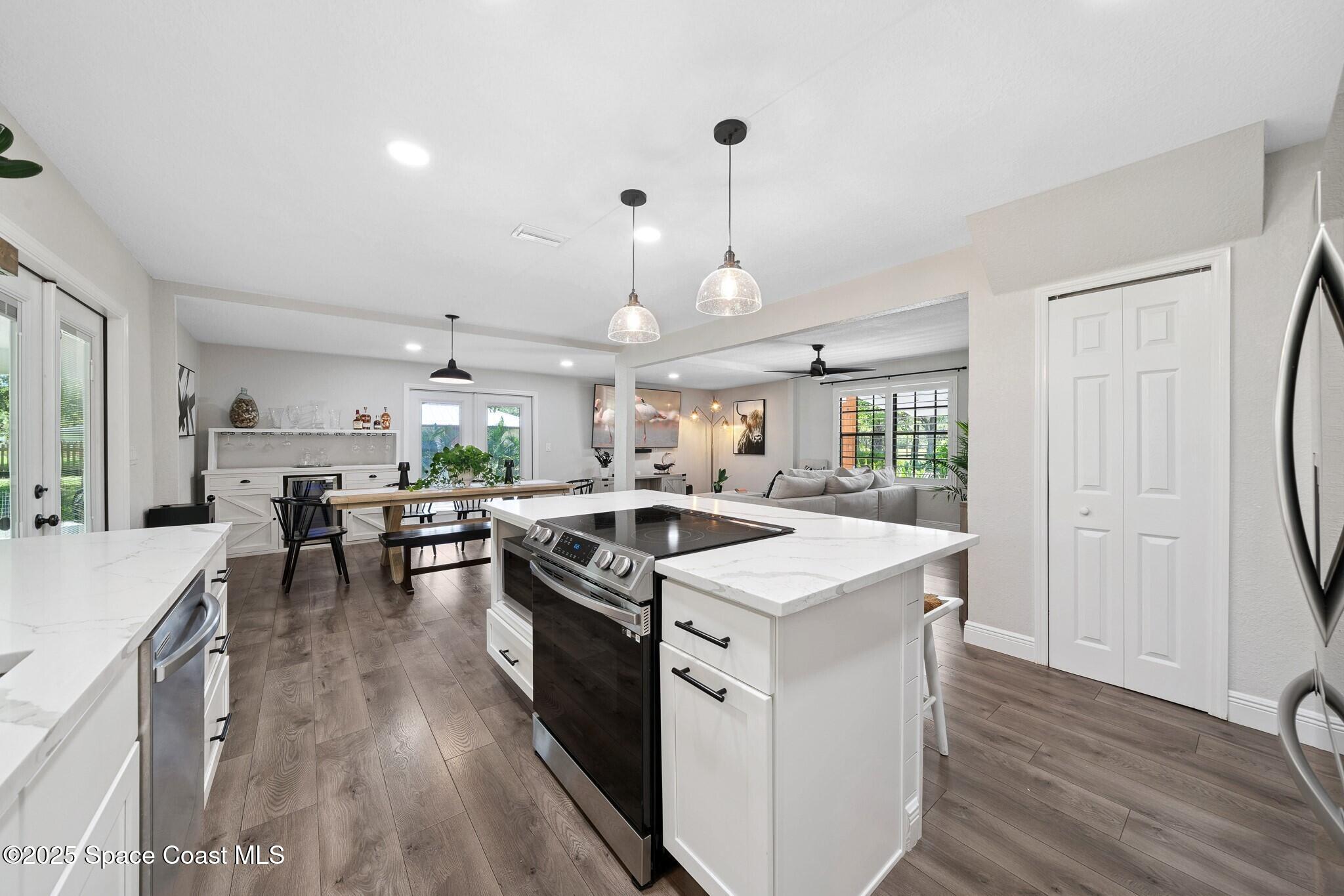 1325 Friday Road Cocoa, FL 32926 - Photo 14 of 59 a kitchen that has a lot of counter space and wooden floor