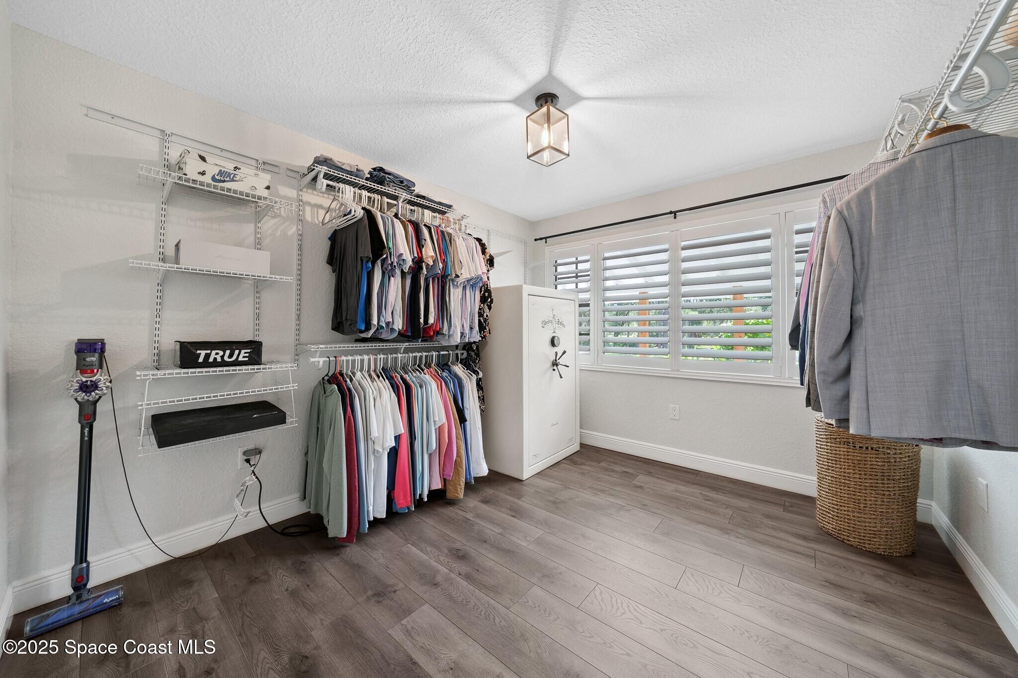 1325 Friday Road Cocoa, FL 32926 - Photo 19 of 59 a view of a walk in closet with clothes and shoes