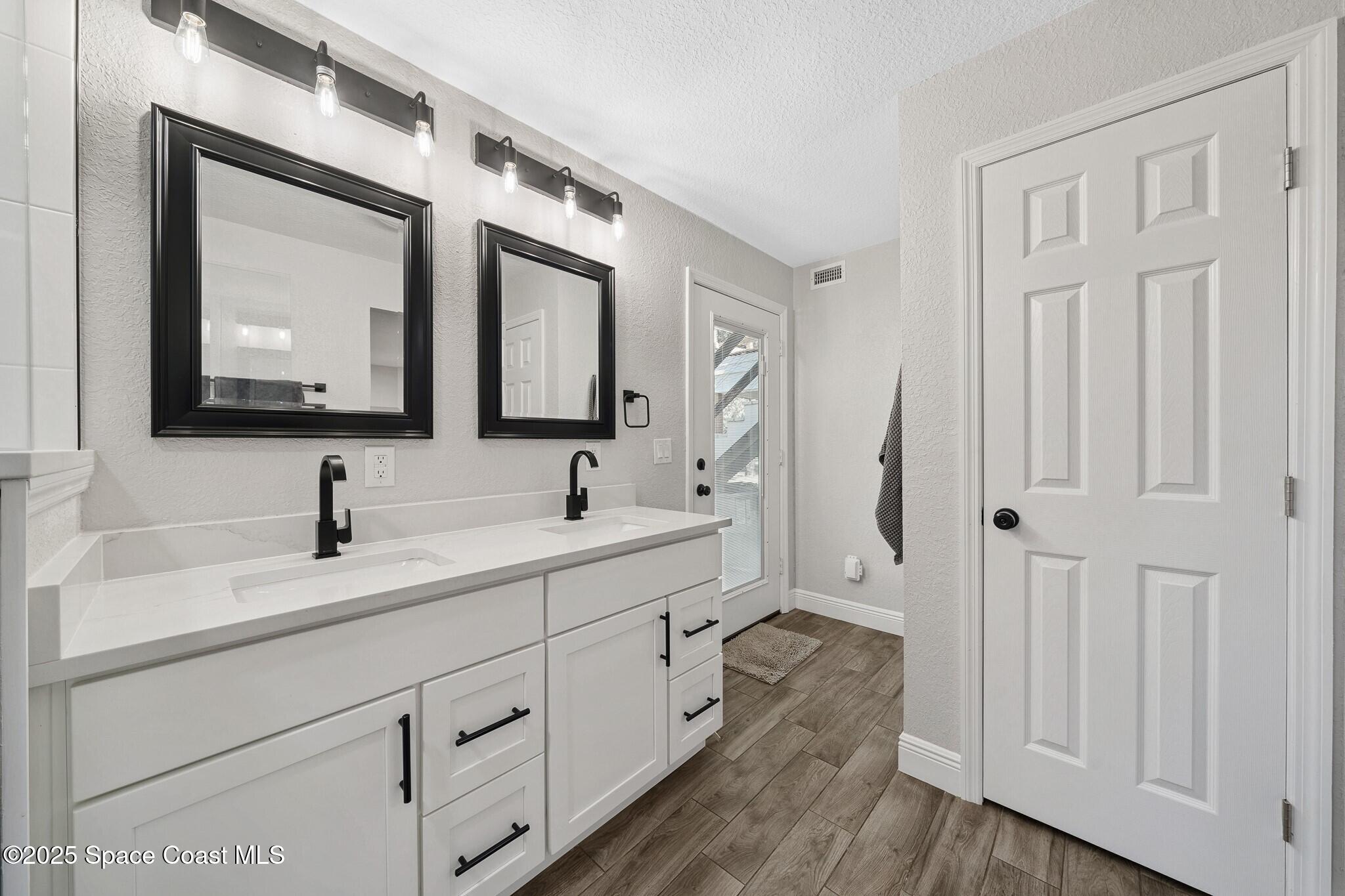 1325 Friday Road Cocoa, FL 32926 - Photo 21 of 59 a bathroom with a double vanity sink and mirror