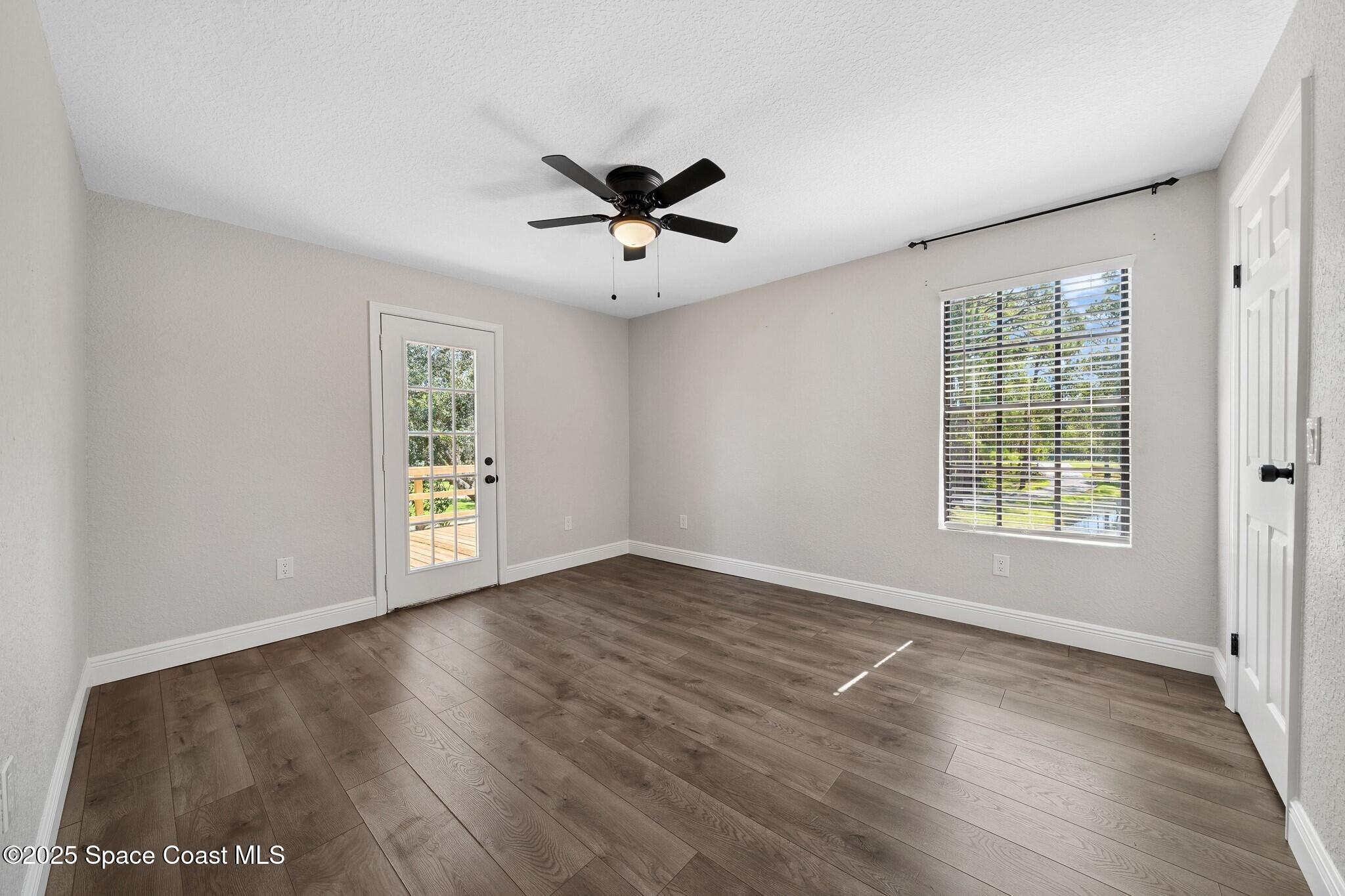 1325 Friday Road Cocoa, FL 32926 - Photo 24 of 59 a view of an empty room with a window and wooden floor