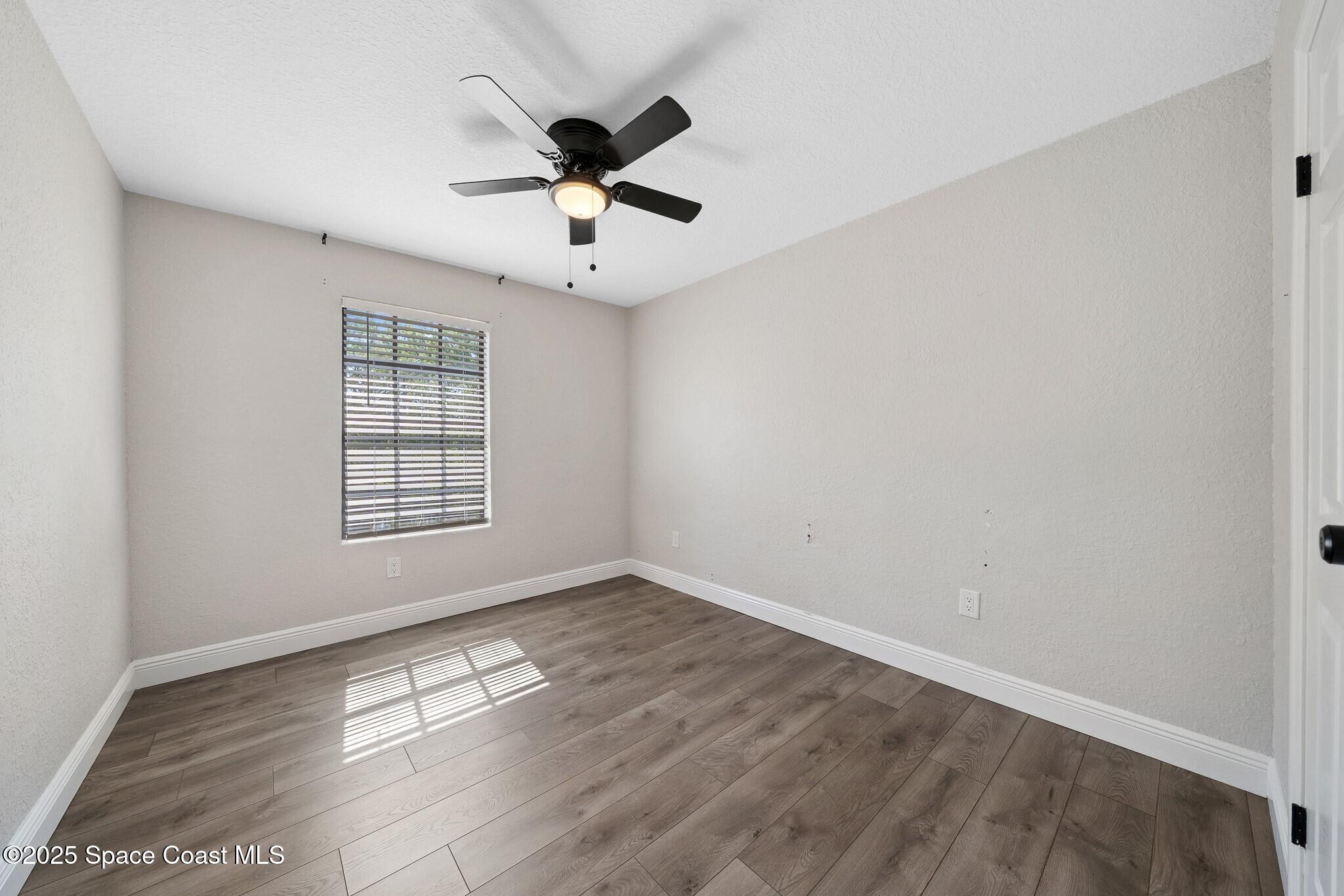 1325 Friday Road Cocoa, FL 32926 - Photo 30 of 59 wooden floor in an empty room with a window