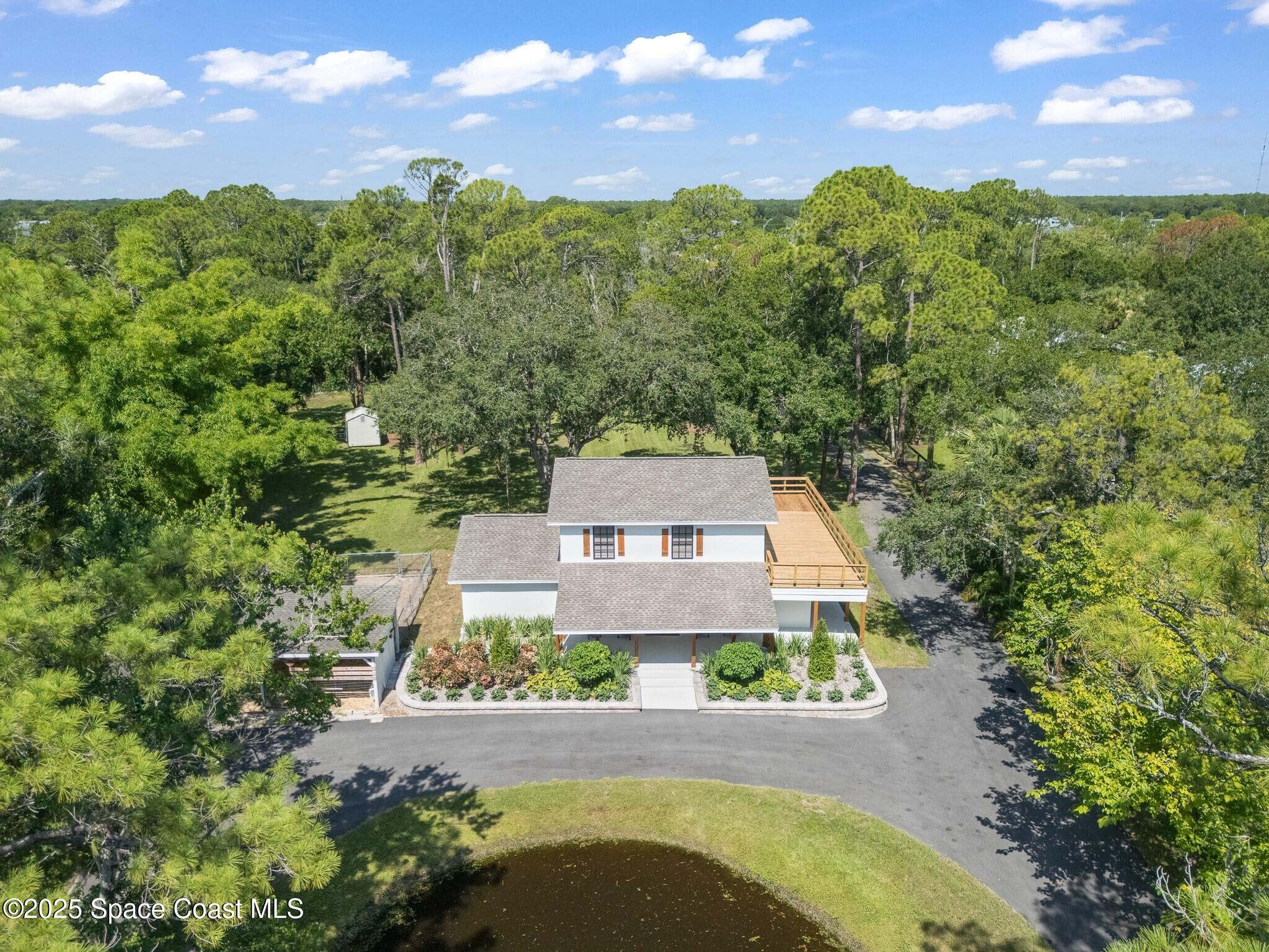 1325 Friday Road Cocoa, FL 32926 - Photo 49 of 59 an aerial view of a house with swimming pool and garden