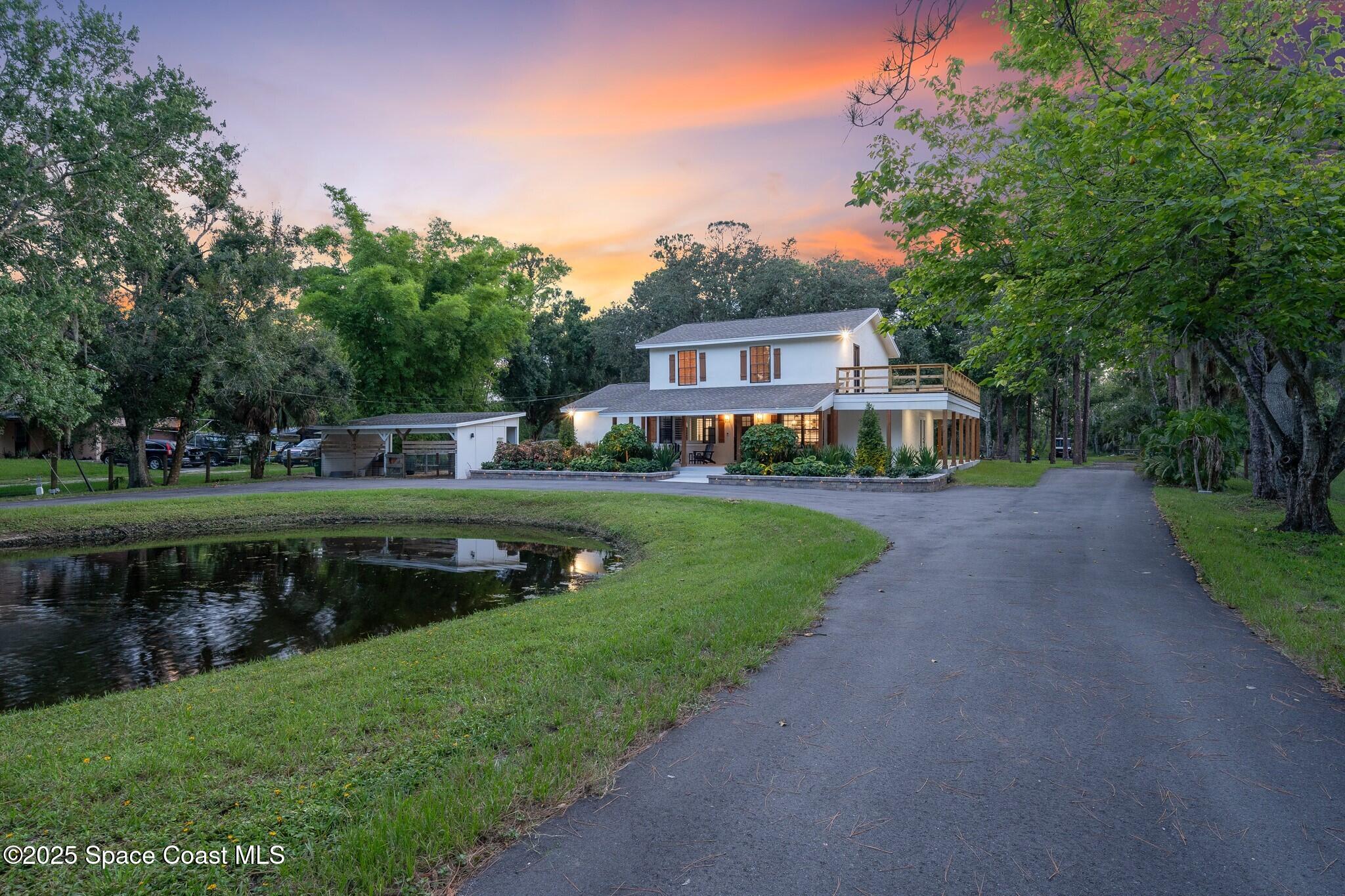 1325 Friday Road Cocoa, FL 32926 - Photo 57 of 59 a front view of a house with a yard table and chairs