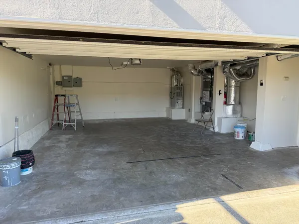 a view of a hallway with a chair and a potted plant