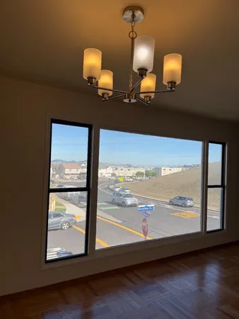 a view of a room with wooden floor and windows
