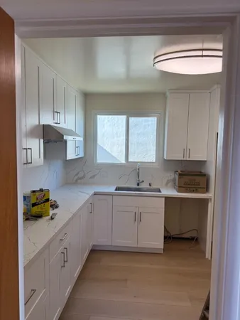 a kitchen with a sink stove and cabinets