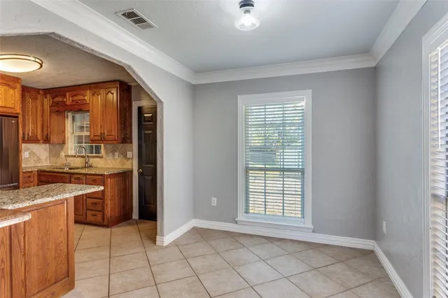a view of a kitchen with a sink stove cabinets and a window
