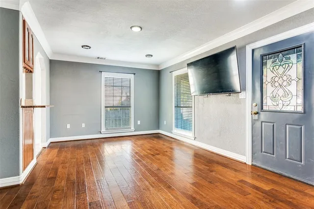 a view of a livingroom with wooden floor and a window