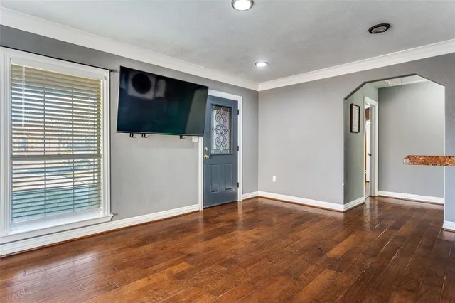 a view of a livingroom with wooden floor and a window