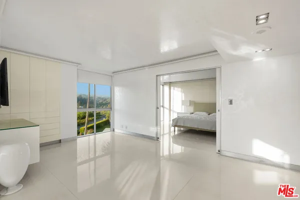 a bedroom with a bed and a view of bathroom