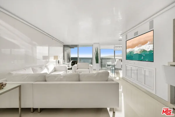 a living room with furniture a large window and a flat screen tv