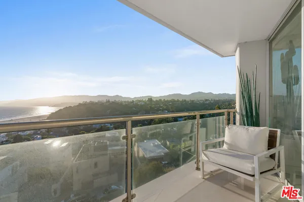 a view of a balcony with furniture
