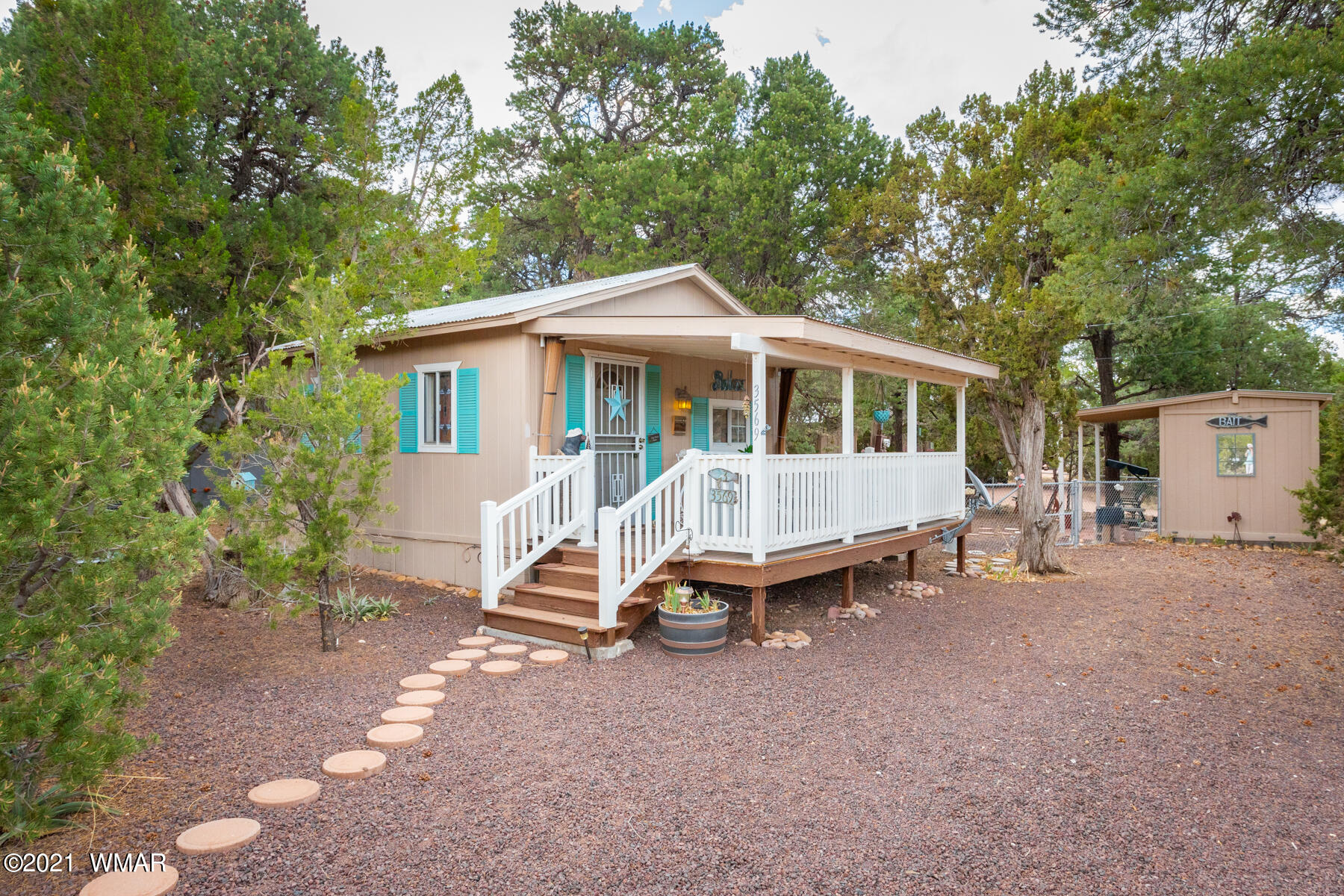 3569 Quail Run Road Overgaard, AZ 85933 - Photo 3 of 23 a house view with a sitting space and garden