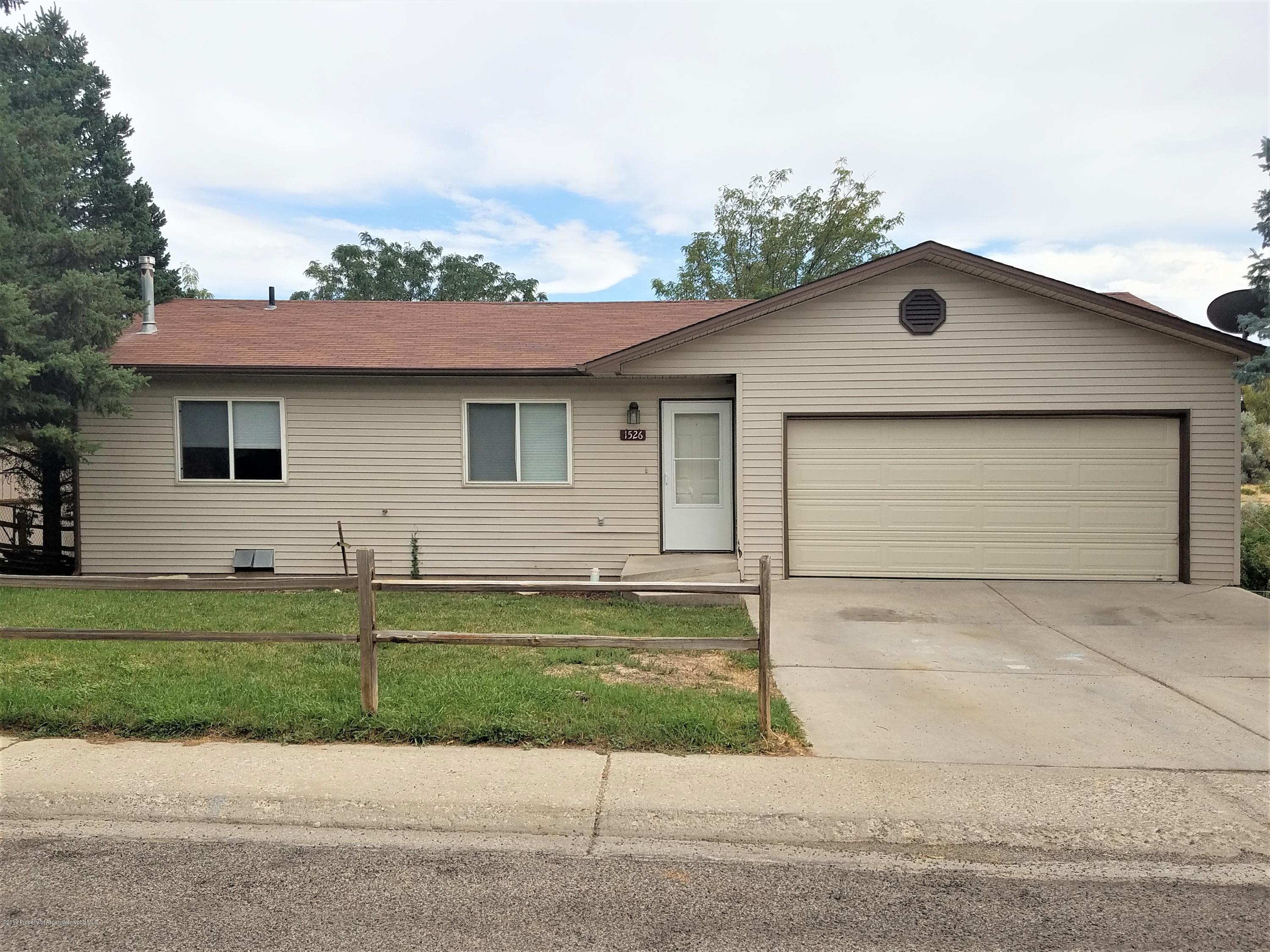 a front view of a house with a yard garage and outdoor seating