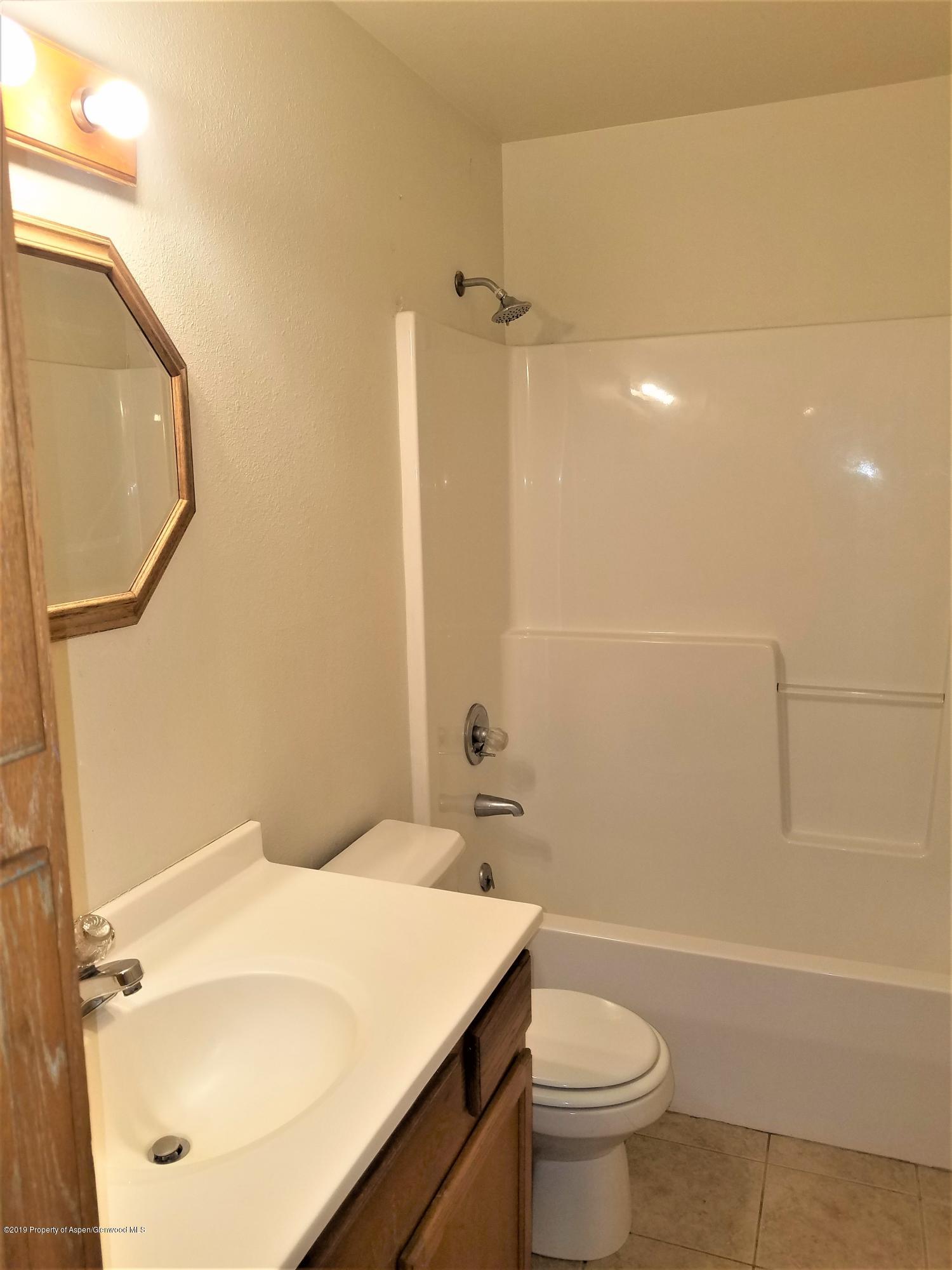1526 Arabian Avenue Rifle, CO 81650 - Photo 13 of 20 a bathroom with a sink a toilet and shower
