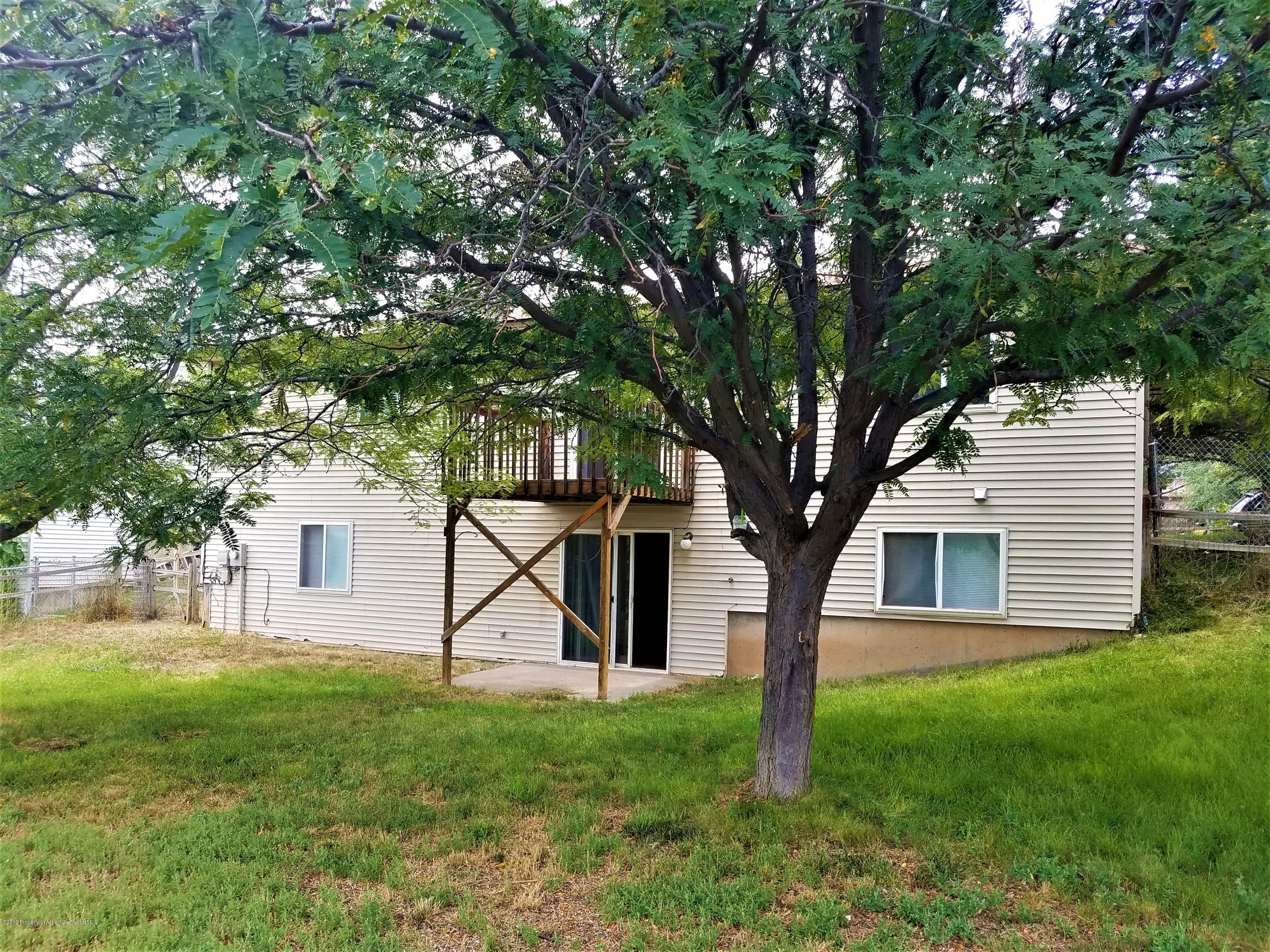 1526 Arabian Avenue Rifle, CO 81650 - Photo 18 of 20 a view of a house with backyard and a tree