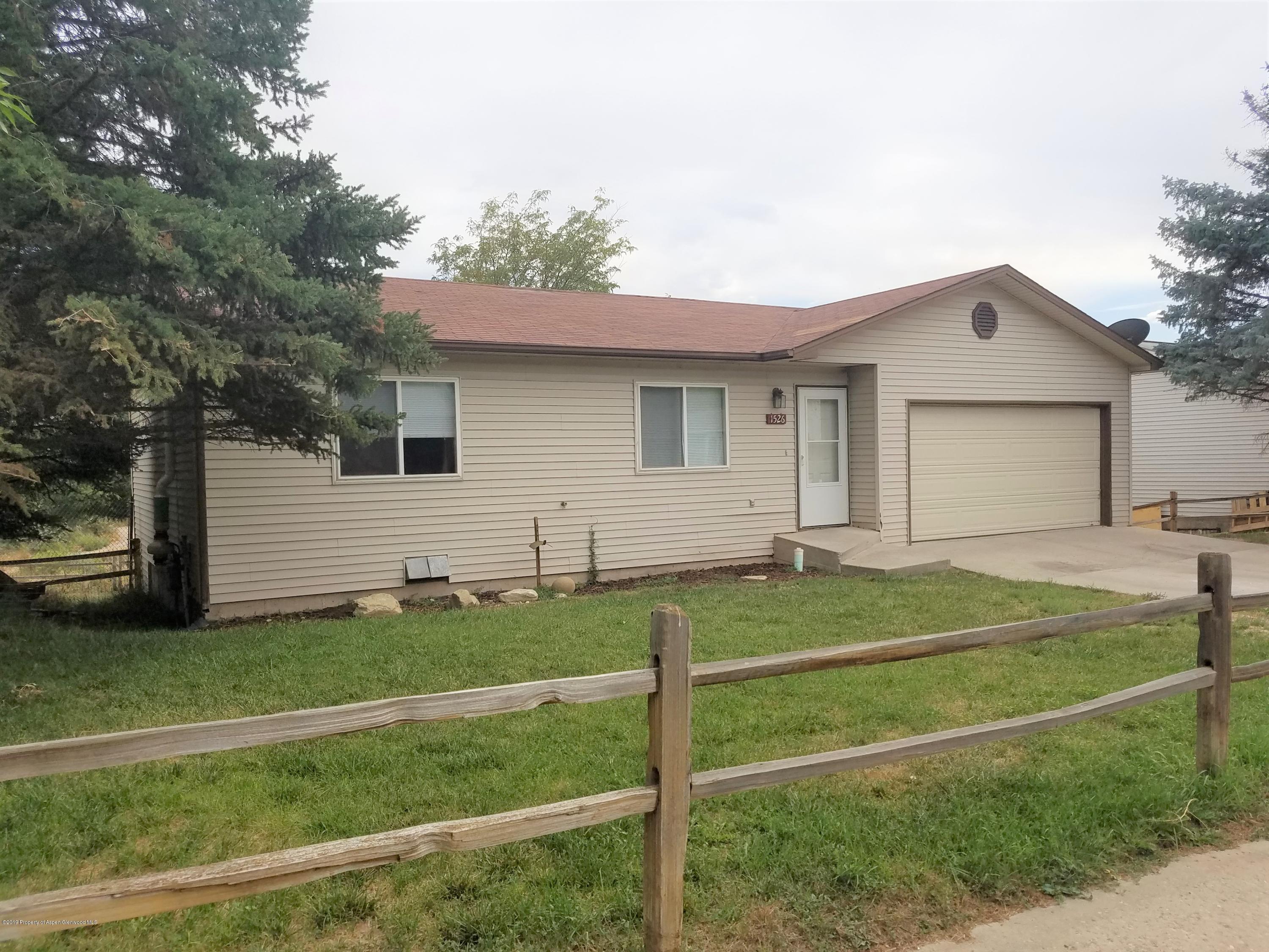 1526 Arabian Avenue Rifle, CO 81650 - Photo 2 of 20 a front view of a house with a yard