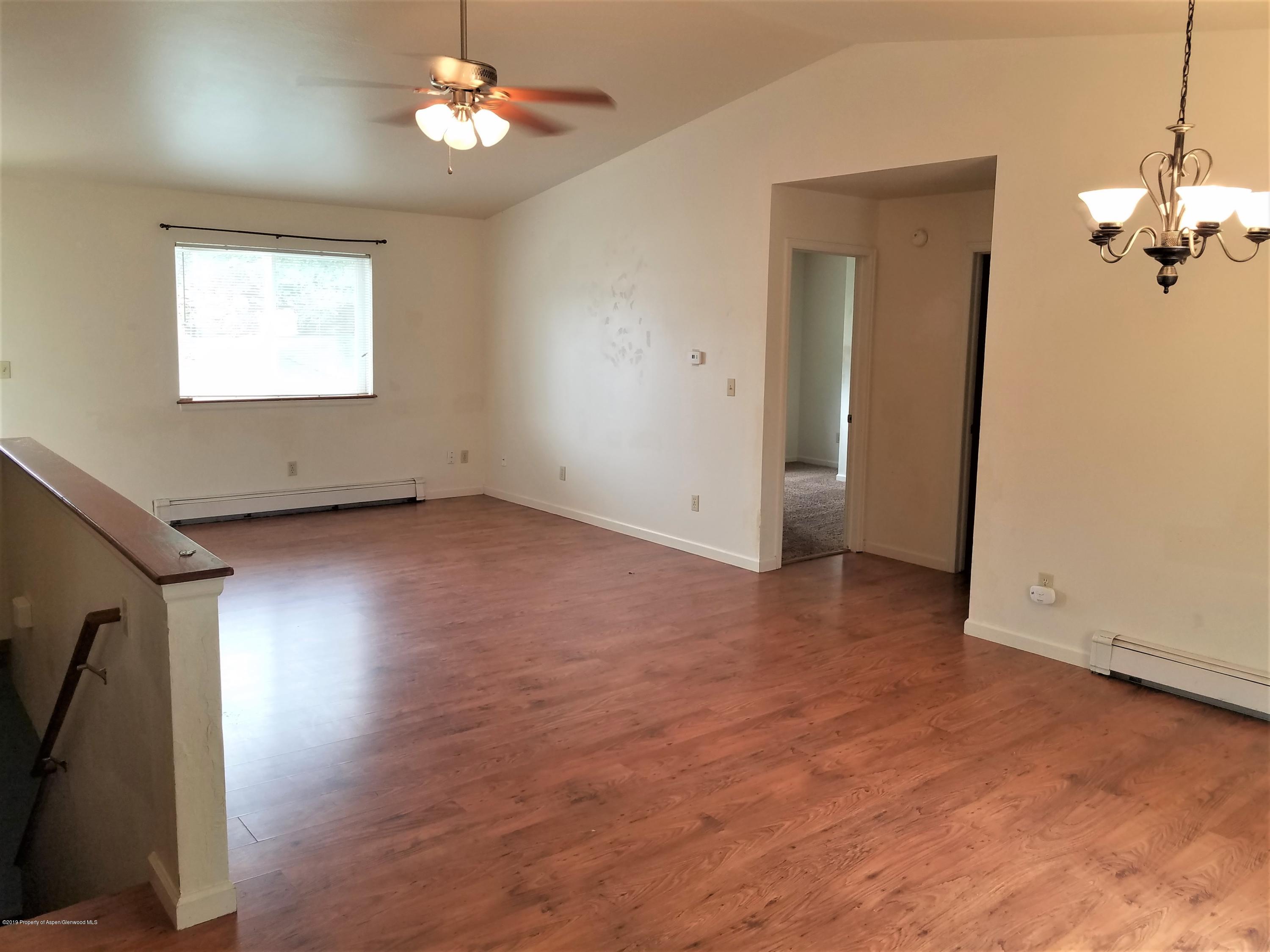 1526 Arabian Avenue Rifle, CO 81650 - Photo 4 of 20 wooden floor in an empty room with a window