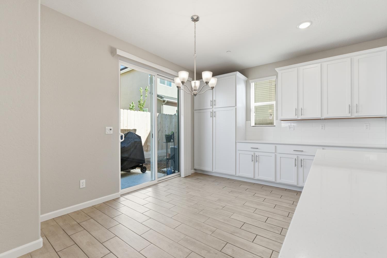 1107 Significant Way West Madera, CA 93636 - Photo 13 of 42 a view of a kitchen with a sink and refrigerator in it