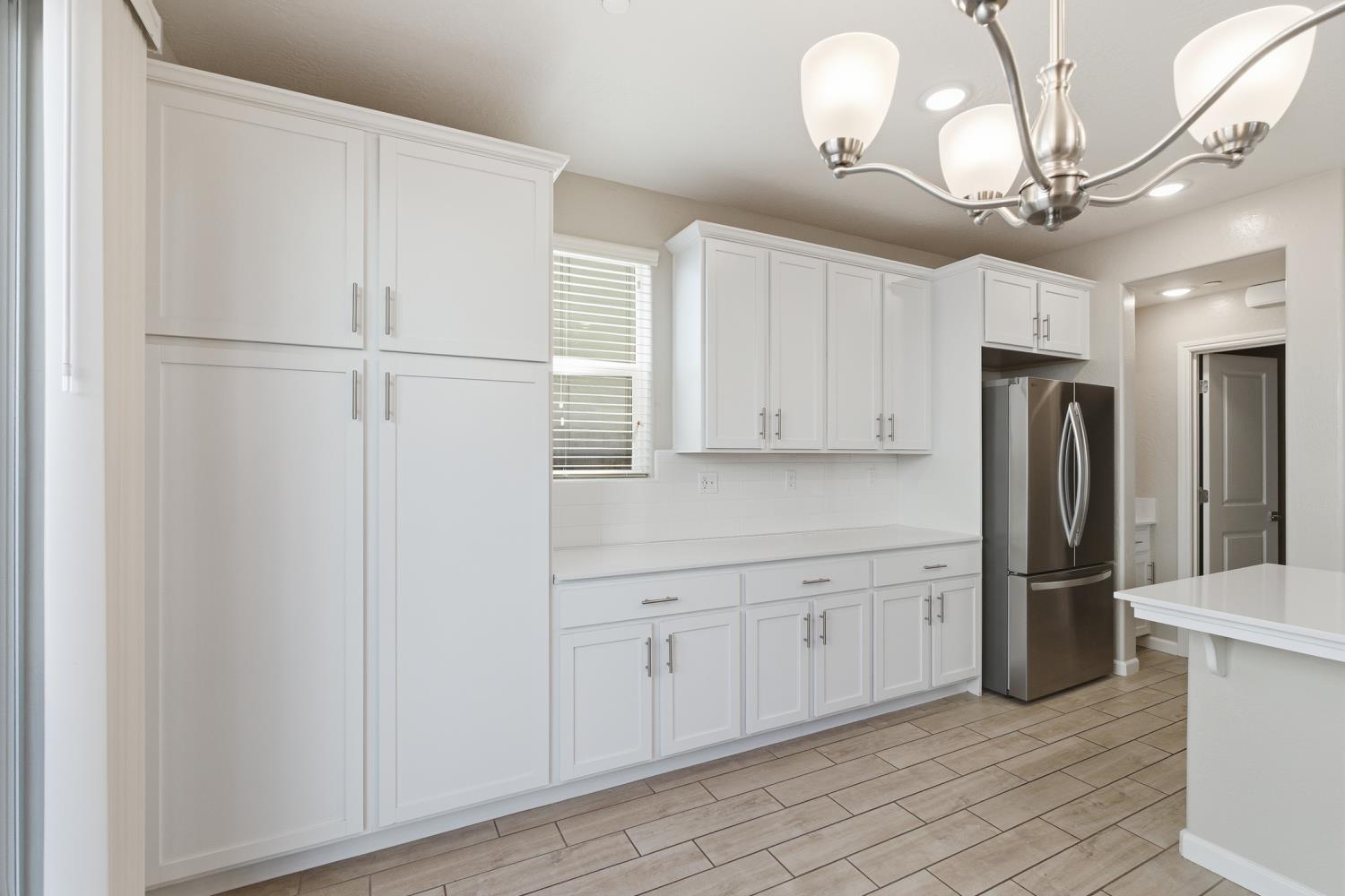 1107 Significant Way West Madera, CA 93636 - Photo 14 of 42 a kitchen with stainless steel appliances a refrigerator and cabinets