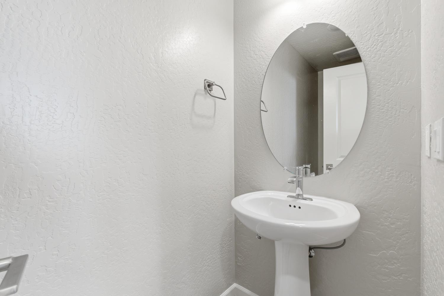 1107 Significant Way West Madera, CA 93636 - Photo 20 of 42 a bathroom with a sink and mirror