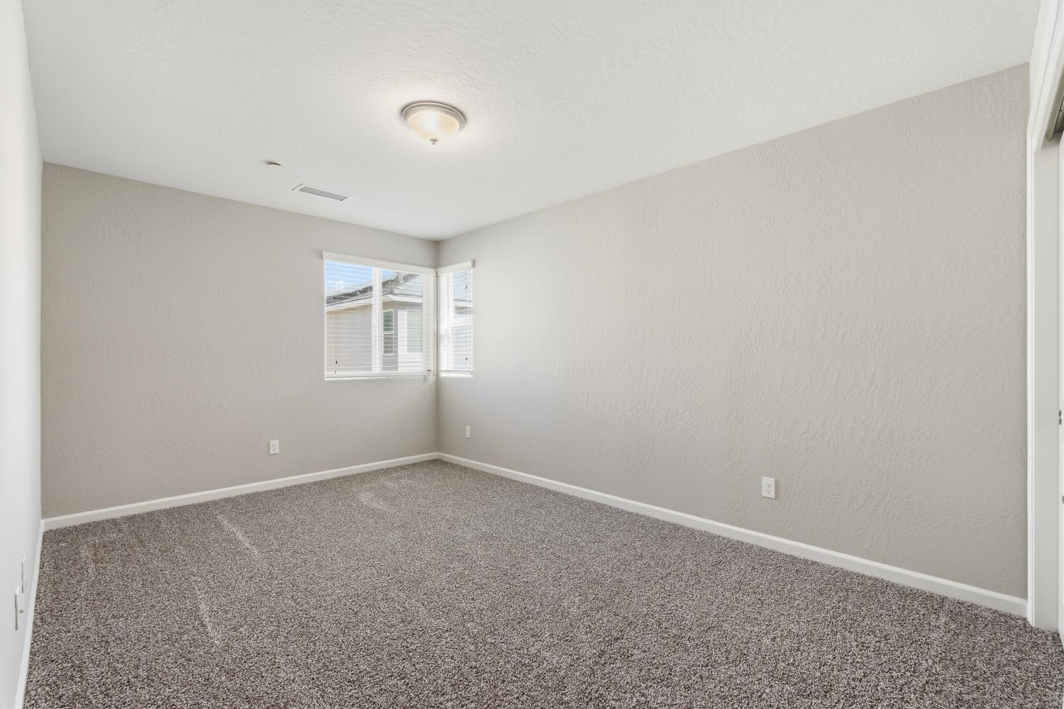1107 Significant Way West Madera, CA 93636 - Photo 23 of 42 a view of an empty room with a window